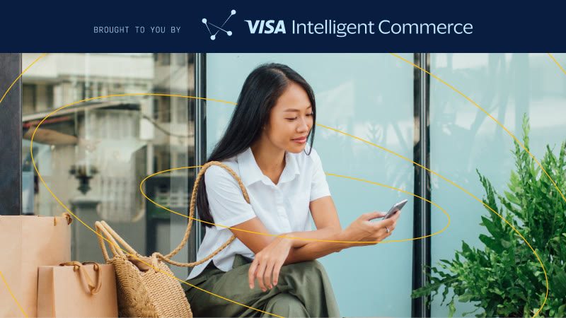 Woman on phone with shopping bags, banner reads BROUGHT TO YOU BY Visa Intelligent Commerce.
