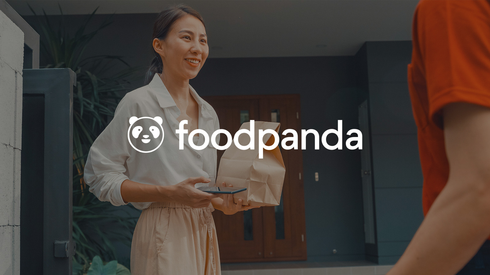 woman receiving foodpanda delivery outside her home