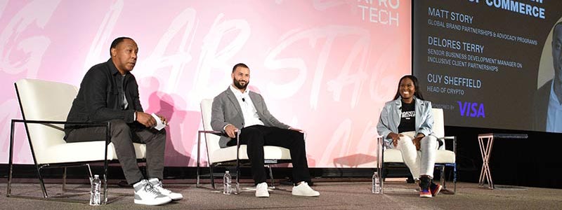 Matt Story, Cuy Sheffield and Delores Terry sit on stage for a panel discussion at AfroTech 2022.