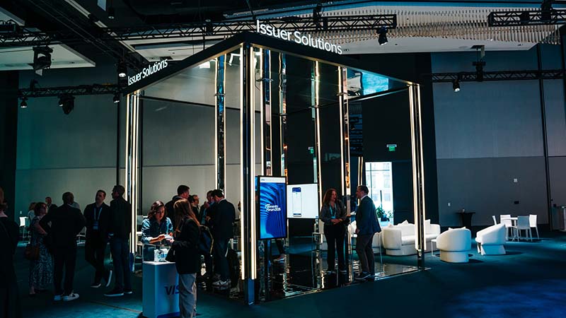 Attendees of Visa Payments Forum stand around the Issuer Solutions booth