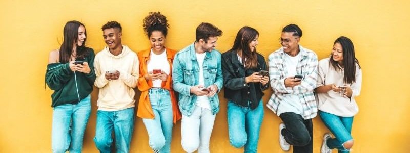 group of young adults using mobile