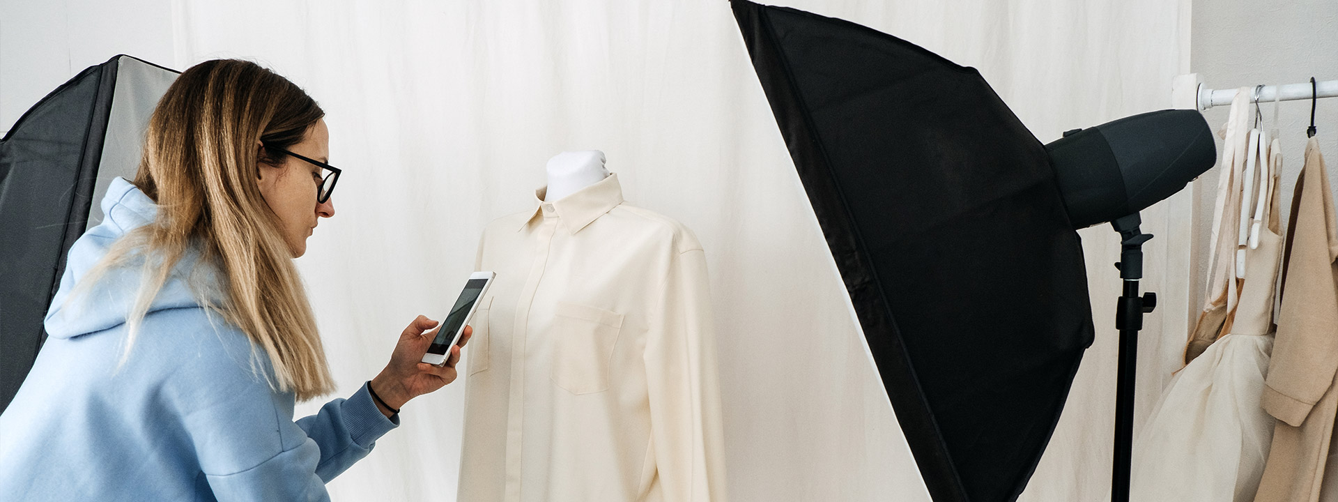 Photographer taking a picture of a shirt for a recommerce shopping website.
