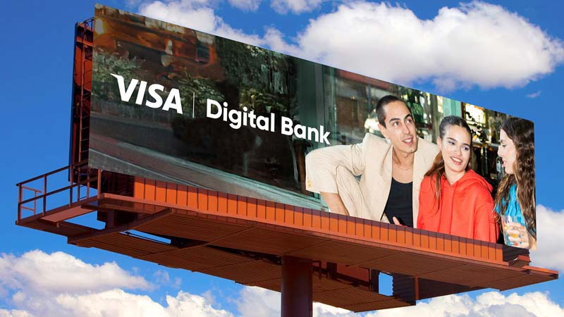 A large billboard with a photograph of three young people, set against bright blue skies and white clouds, promoting Visa Digital Bank