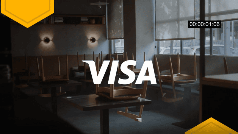 Empty cafe with chairs on tables, Visa logo displayed in the center.
