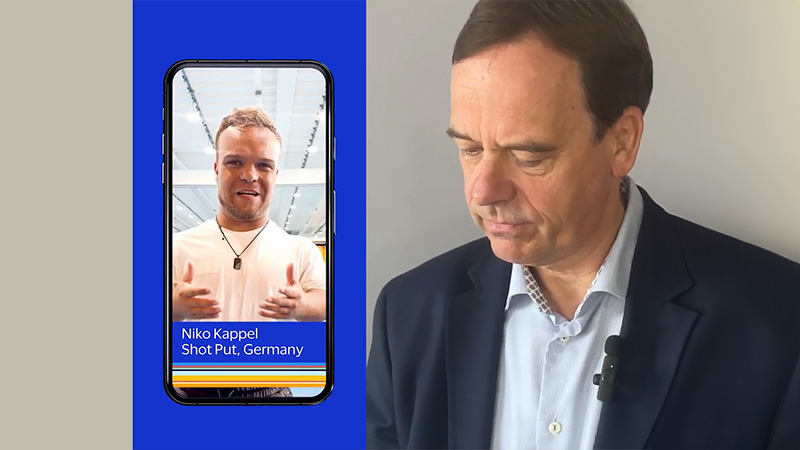 A man glancing down engaged in a phone conversation with German paralympic athlete Niko Kappel