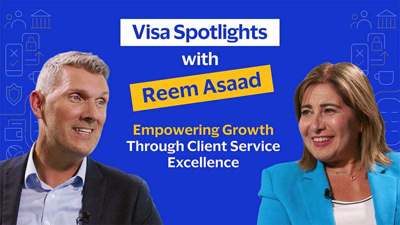 Man and woman smiling against a blue background. Text: 'Visa Spotlights with Reem Asaad: Empowering Growth Through Client Service Excellence.'