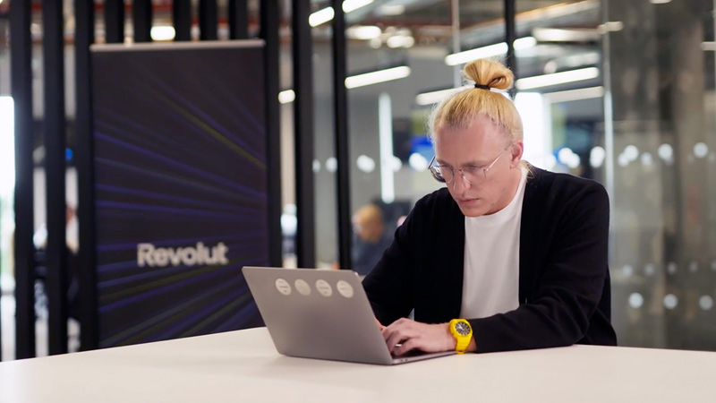 Dmytro Strelchuk, Strategy and Operations Lead at Revolut, working on a laptop