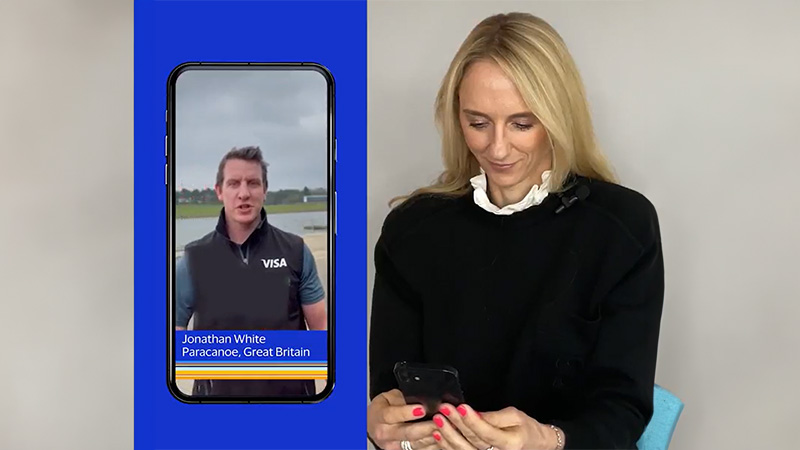 A women glancing down at her phone engaged in a phone conversation with Paralympian canoeist Jonathan White