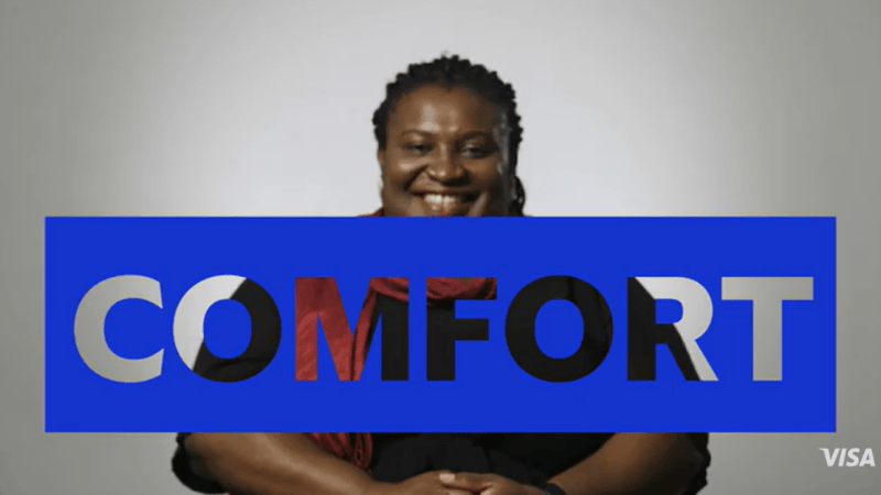 Lady smiling with blue cut out sign that says Comfort
