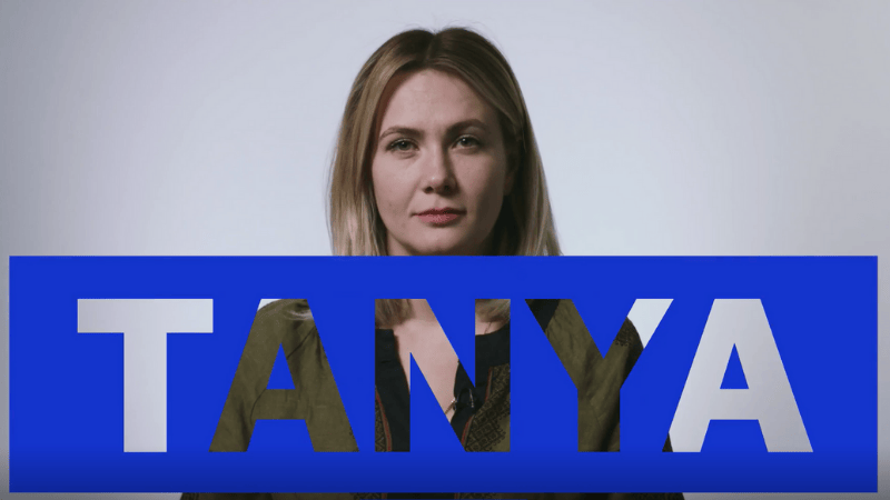 Lady with blue cut out sign that says Tanya